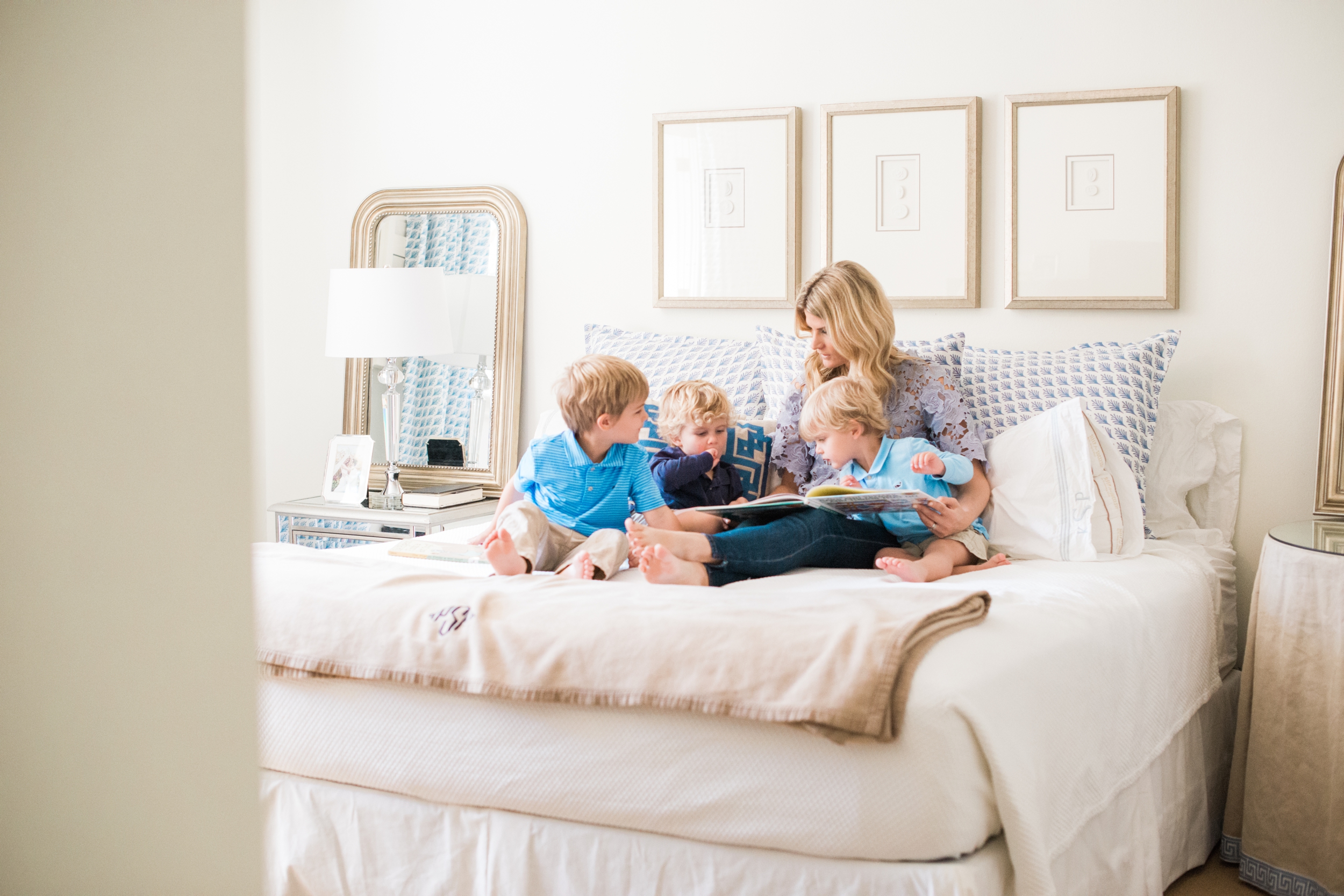 mother and sons reading books on the bed in Briar Grove 