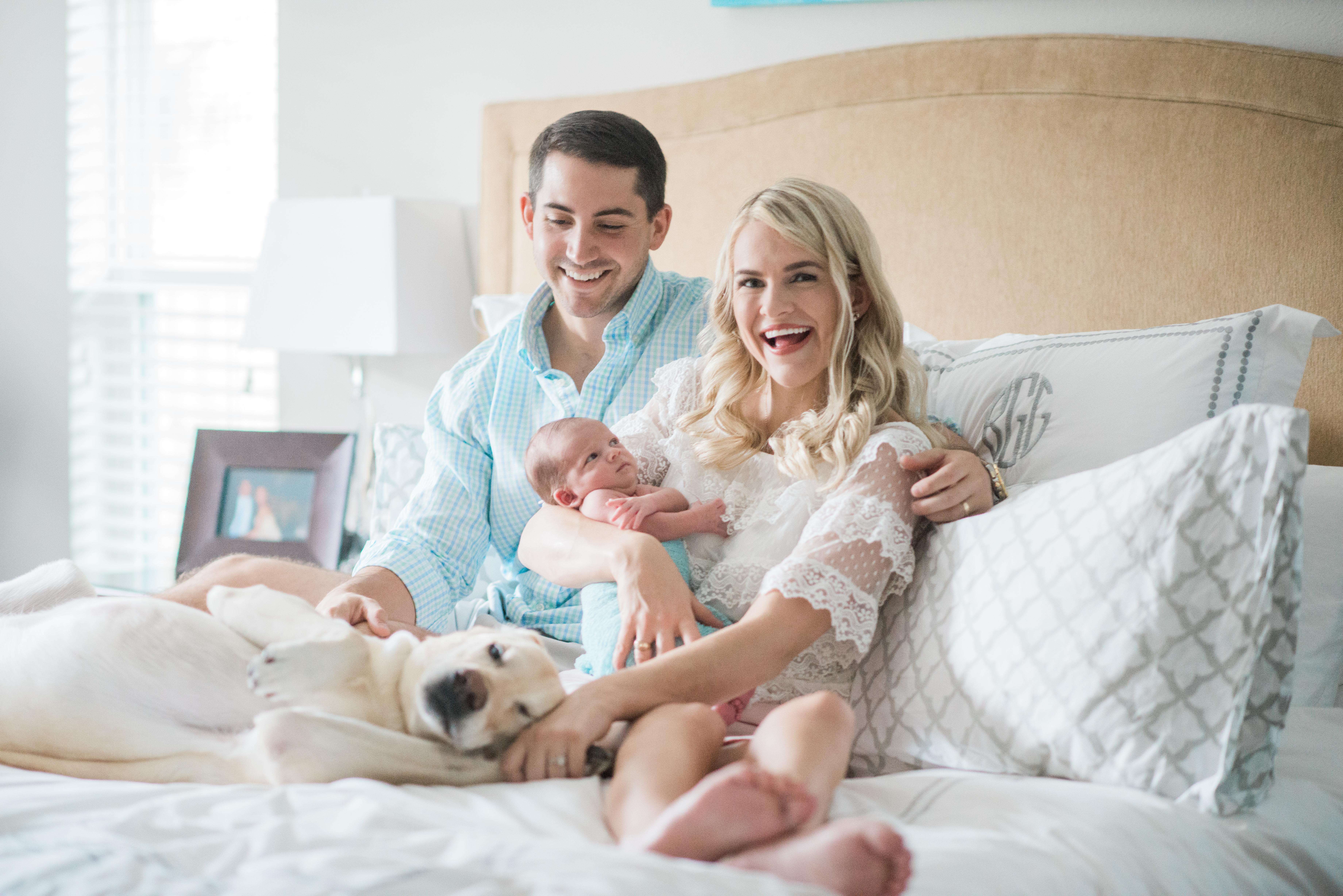family on bed with dog